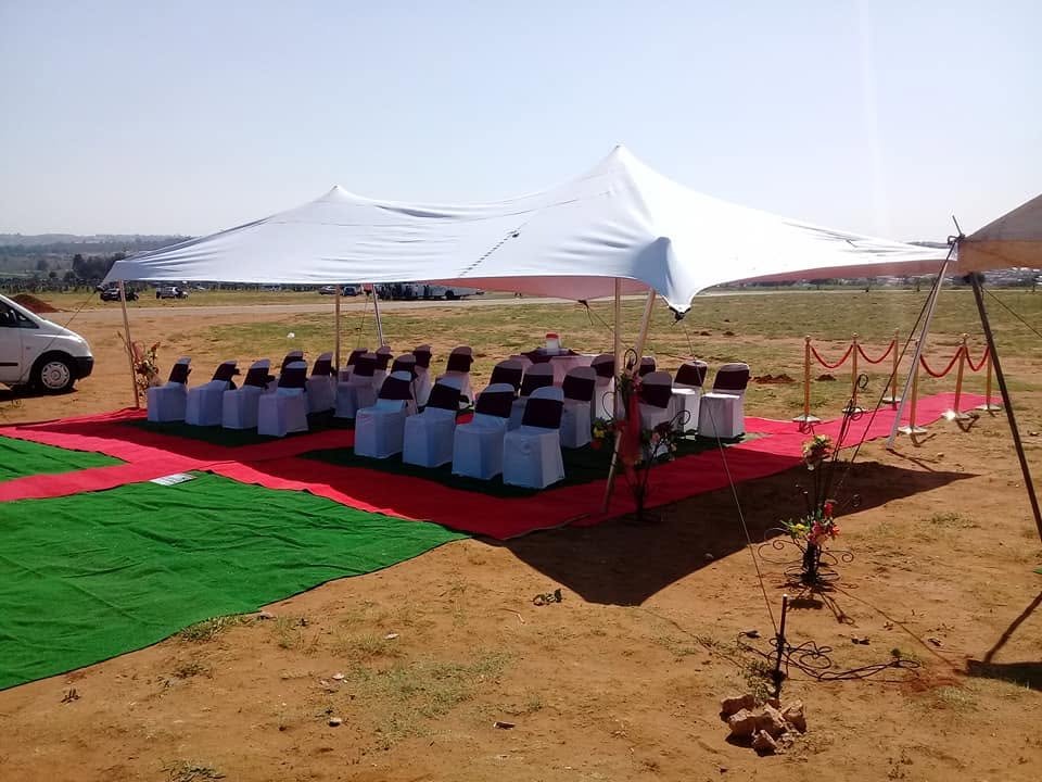 White tent with chairs prepared for a funeral