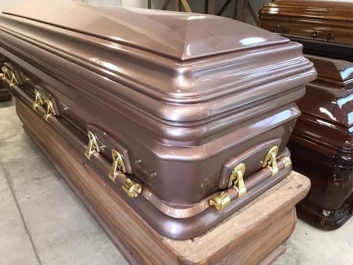 Casket with gold-coloured handles in the showroom